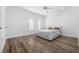 This light and airy bedroom features wood-look floors, a ceiling fan, and bright white walls at 2240 Soho Bay Ct, Tampa, FL 33606