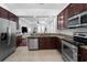Kitchen showcasing granite countertops, stainless steel appliances, and dark wood cabinetry at 2240 Soho Bay Ct, Tampa, FL 33606
