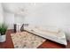 White living room featuring white sofas, hardwood floors, and a neutral patterned rug at 2240 Soho Bay Ct, Tampa, FL 33606