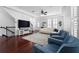 Bright living room featuring dark wood floors, tray ceilings, and plantation shutters at 2240 Soho Bay Ct, Tampa, FL 33606