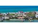 Beautiful beachfront property with manicured lawns, palm trees, and a charming coastal ambiance at 2411 And 2407 Casey Key Rd, Nokomis, FL 34275