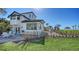 Spacious backyard featuring lush greenery, a cozy lounge area, and stunning ocean views at 2411 And 2407 Casey Key Rd, Nokomis, FL 34275