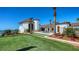 Beautiful backyard showcasing a lush lawn, patio with dining set, and meticulous landscaping at 2411 And 2407 Casey Key Rd, Nokomis, FL 34275