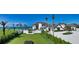 Expansive backyard with well-manicured lawn, beach access, a putting green, and lush tropical landscaping at 2411 And 2407 Casey Key Rd, Nokomis, FL 34275
