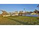Sprawling backyard with large green lawn, mature trees, and privacy fencing at 2411 And 2407 Casey Key Rd, Nokomis, FL 34275