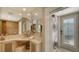 Well-lit bathroom with modern fixtures, vanity, sink, and a convenient washer and dryer at 2411 And 2407 Casey Key Rd, Nokomis, FL 34275