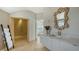 Well-lit bathroom with modern fixtures, a walk-in shower, and a unique seashell mirror at 2411 And 2407 Casey Key Rd, Nokomis, FL 34275