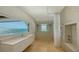 Bright bathroom featuring modern vanity, a walk-in shower, and stunning ocean view at 2411 And 2407 Casey Key Rd, Nokomis, FL 34275