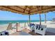 Beautiful beachside deck with comfy seating and a shaded palapa for enjoying stunning ocean views at 2411 And 2407 Casey Key Rd, Nokomis, FL 34275