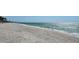 Expansive view of a sandy beach meeting the ocean's edge, perfect for relaxation and enjoying the coastal scenery at 2411 And 2407 Casey Key Rd, Nokomis, FL 34275