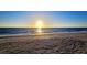 Scenic beach view featuring soft sand and calm ocean waves during a vibrant sunset at 2411 And 2407 Casey Key Rd, Nokomis, FL 34275