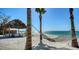 Serene beach scene featuring a gazebo and hammock offering relaxing ocean views and coastal charm at 2411 And 2407 Casey Key Rd, Nokomis, FL 34275