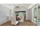 Elegant dining room with modern chandelier, herringbone floors, and lake view at 2411 And 2407 Casey Key Rd, Nokomis, FL 34275