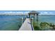 Inviting dock featuring a covered gazebo with swings, providing a serene waterfront escape at 2411 And 2407 Casey Key Rd, Nokomis, FL 34275