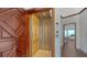 Interior elevator with wood paneling and metal accordion gate at 2411 And 2407 Casey Key Rd, Nokomis, FL 34275
