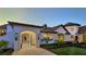 Elegant entryway with arched doorway, stone walkway, and lush landscaping at 2411 And 2407 Casey Key Rd, Nokomis, FL 34275