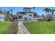Elegant home with lush green lawn, stone walkway, and stylish architecture at 2411 And 2407 Casey Key Rd, Nokomis, FL 34275