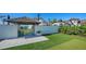 Beautifully landscaped backyard featuring a gazebo and seating area, enhancing the outdoor living space of this elegant estate at 2411 And 2407 Casey Key Rd, Nokomis, FL 34275