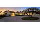 Luxury property with circular driveway, manicured lawn, and elegant architectural design at sunset at 2411 And 2407 Casey Key Rd, Nokomis, FL 34275