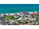 Elegant beachfront home with a manicured lawn, pristine beach, and serene coastal views at 2411 And 2407 Casey Key Rd, Nokomis, FL 34275