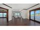 Spacious living room with dark hardwood floors, water views, and access to the outdoors at 2411 And 2407 Casey Key Rd, Nokomis, FL 34275