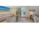 Relaxing living area with comfortable seating, tile flooring, and a large screen television at 2411 And 2407 Casey Key Rd, Nokomis, FL 34275