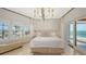 Serene main bedroom with ocean views, white bedding, and a sliding glass door to a balcony at 2411 And 2407 Casey Key Rd, Nokomis, FL 34275