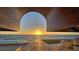Stunning outdoor space showcasing a unique archway framing ocean views and comfortable seating areas at 2411 And 2407 Casey Key Rd, Nokomis, FL 34275