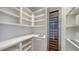 Well-organized pantry with ample shelving and a wine refrigerator for beverage storage at 2411 And 2407 Casey Key Rd, Nokomis, FL 34275