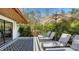 Inviting outdoor patio featuring comfortable lounge chairs, modern black and white tilework, and lush landscaping at 2411 And 2407 Casey Key Rd, Nokomis, FL 34275