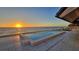 Beautiful beachside pool featuring tile decking and scenic ocean view during sunset at 2411 And 2407 Casey Key Rd, Nokomis, FL 34275