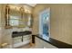 Stylish powder room with ornate mirror, modern fixtures, and decorative wallpaper at 2411 And 2407 Casey Key Rd, Nokomis, FL 34275