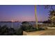 Picturesque waterfront view with a gazebo, palm trees, and a starlit sky at 2411 And 2407 Casey Key Rd, Nokomis, FL 34275