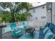 Back porch with outdoor seating overlooking a refreshing pool and lush greenery at 2921 W El Prado Blvd, Tampa, FL 33629