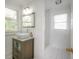 Bright bathroom with a vessel sink, a vanity with drawers, and a shower at 2921 W El Prado Blvd, Tampa, FL 33629