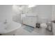 Elegant bathroom featuring a standalone tub, a double sink vanity, glass shower, and modern fixtures at 2921 W El Prado Blvd, Tampa, FL 33629