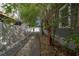 Long driveway leading to a detached garage, lined with mature trees and landscaping at 2921 W El Prado Blvd, Tampa, FL 33629