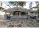 Charming craftsman style bungalow with a spacious front porch and a gray brick driveway at 2921 W El Prado Blvd, Tampa, FL 33629