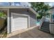 Side view of house, featuring a one-car garage, stairs to pool, and a glimpse of backyard swimming pool at 2921 W El Prado Blvd, Tampa, FL 33629