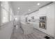 Spacious, well-lit kitchen featuring an island with marble countertop, stainless steel appliances, and white cabinetry at 2921 W El Prado Blvd, Tampa, FL 33629