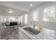 Open-concept kitchen with marble countertops and island, stainless steel faucet, and views of the dining and living areas at 2921 W El Prado Blvd, Tampa, FL 33629