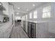 Modern kitchen featuring a center island with marble countertops, stainless steel appliances, and white cabinetry at 2921 W El Prado Blvd, Tampa, FL 33629