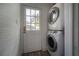 Bright laundry room with stackable washer/dryer and exterior door with window panes at 2921 W El Prado Blvd, Tampa, FL 33629