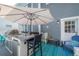 Outdoor kitchen and patio area with built-in grill, bar seating, and plenty of space to entertain at 2921 W El Prado Blvd, Tampa, FL 33629