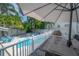Beautiful pool area with outdoor seating, an outdoor kitchen area, and lush landscaping at 2921 W El Prado Blvd, Tampa, FL 33629