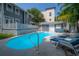 Backyard pool with patio seating, lush landscaping, and an outdoor kitchen at 2921 W El Prado Blvd, Tampa, FL 33629