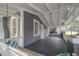 Relaxing outdoor porch with a hanging swing, elegant lighting, and a smooth dark floor at 2921 W El Prado Blvd, Tampa, FL 33629