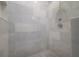 A close-up of the pristine tiled shower stall with modern fixtures and a built-in niche at 2921 W El Prado Blvd, Tampa, FL 33629