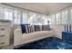Bright sun room with a comfortable white sofa, blue accents, and multiple windows at 2921 W El Prado Blvd, Tampa, FL 33629