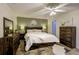 Comfortable bedroom with a rustic wooden bed frame, soft lighting, and stylish decor at 3241 Cullendale Dr, Tampa, FL 33618